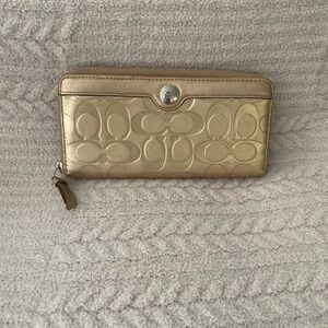 Coach Gold Wallet with Signature Embossed Pattern